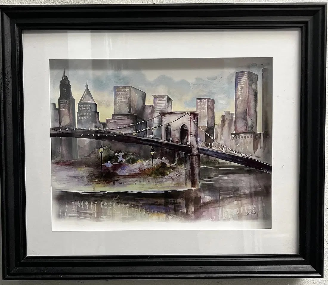 Tre Sorelle "Watercolor Shyline" Framed under Glass: Capturing the essence of community life with a contemporary art twist, the "Watercolor Shyline" by Tre Sorelle offers an original glimpse into the vibrant pulse of cities and towns. This medium-sized 