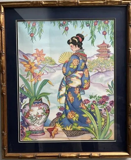 MARTY NOBLE "JAPANESE GIRL IN GARDEN " SIGNED LOWER LEFT FRAMED PRINT: This is a framed art print depicting a Japanese woman in a garden. Subject: A woman in a blue kimono with floral patterns, holding a yellow fan, is the central figure. Her hair is styled in a traditio