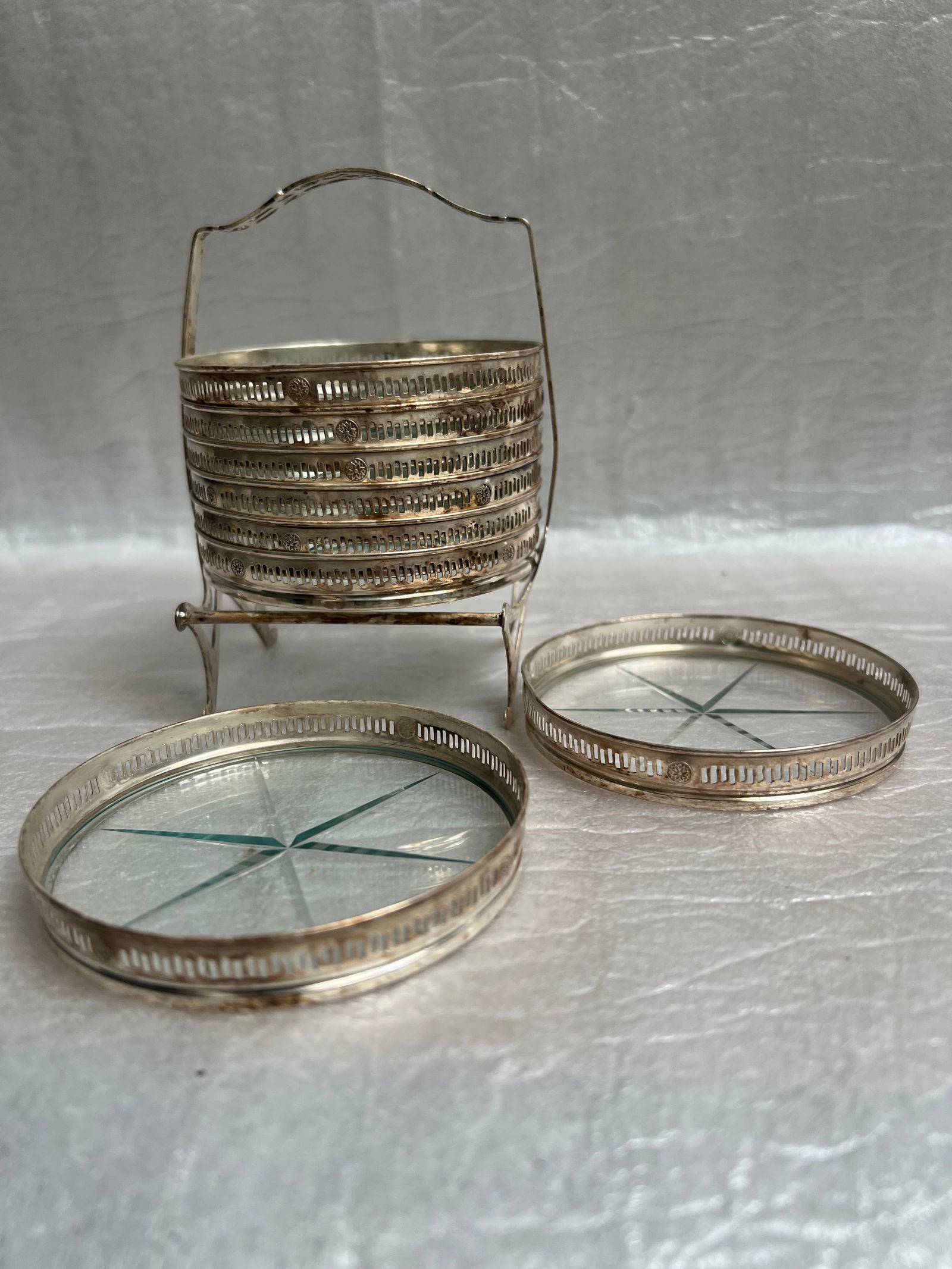 Art Deco Sterling and Cut Glass Coaster Set: This is a vintage or antique set of sterling silver and glass coasters with a matching caddy . These sets were popular from the early 1900s through the mid-20th century. DescriptionMaterial: The rims