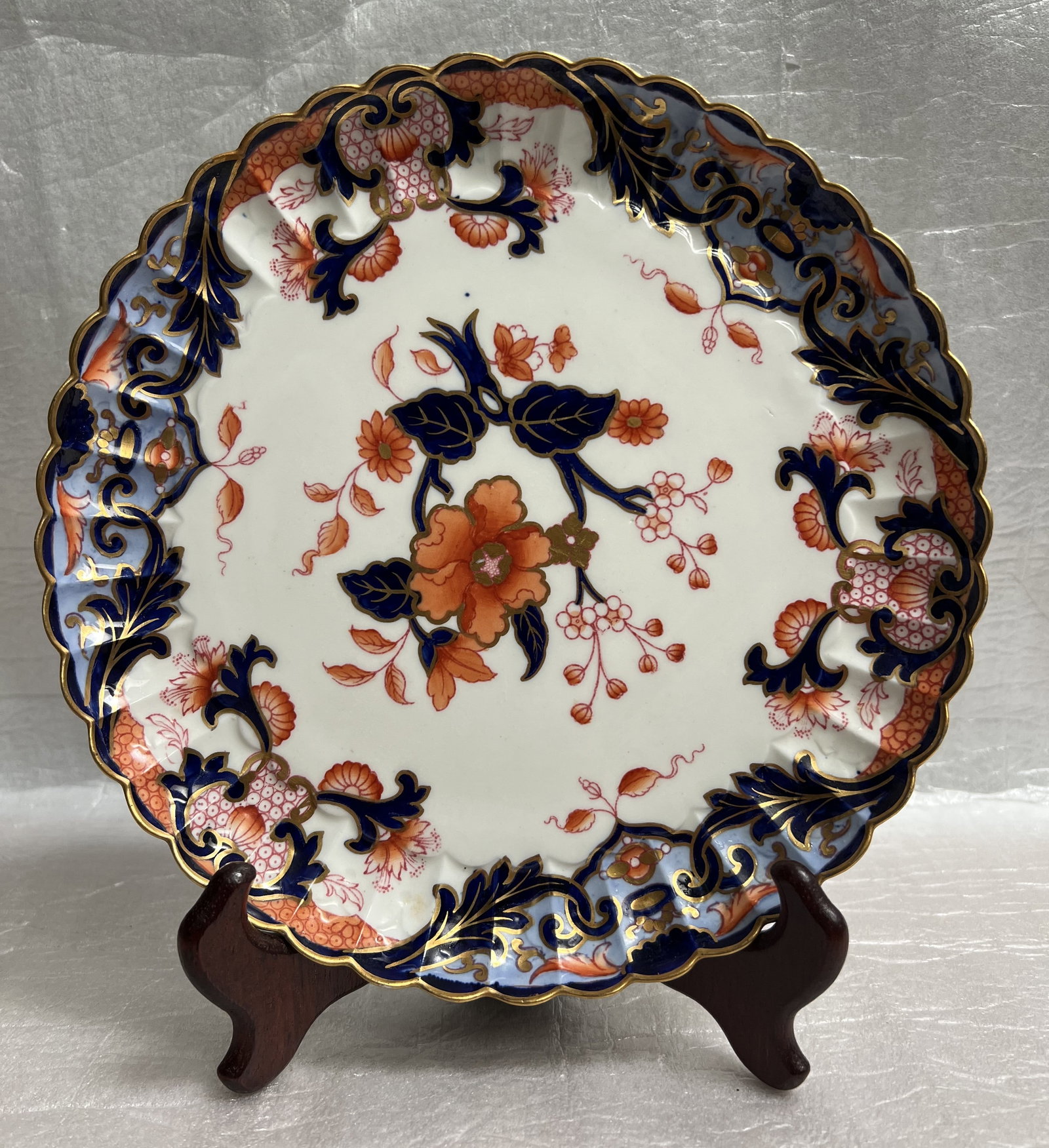 Tiffany & Co Royal Crown Derby in Old Imari Pattern: The plate in the image is a Royal Crown Derby plate in the traditional "Kings" or "Old Imari" pattern. This specific pattern is characterized by its ornate, hand-painted design using cobalt blue, vibr