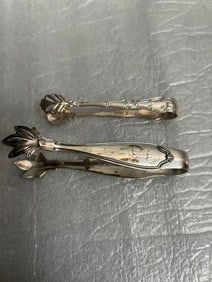 a pair of sterling silver sugar tongs