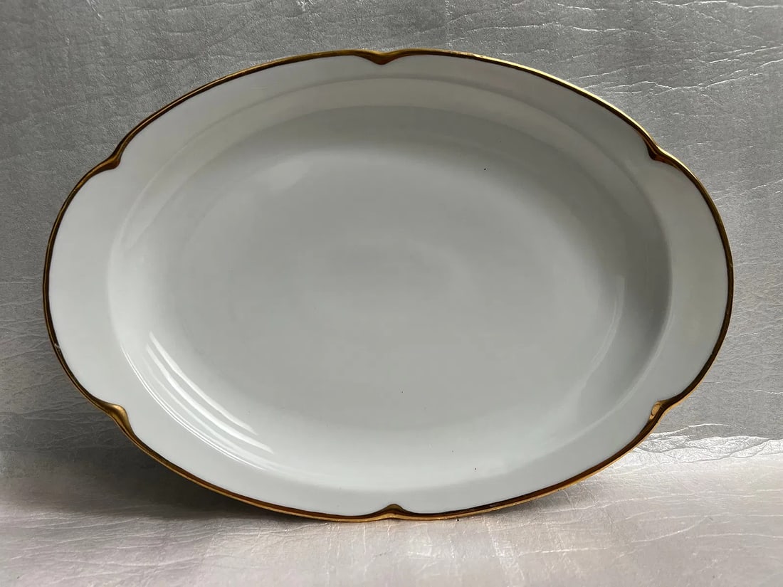 Large Serving Dish 12"W O &E Royal Austria With 24K Gold Trim: This large serving dish from Royal Austria is a stunning addition to any collection. With its oval shape and 24K gold trim, it is sure to impress. Measuring 12 inches in width and 8 inches in depth, i