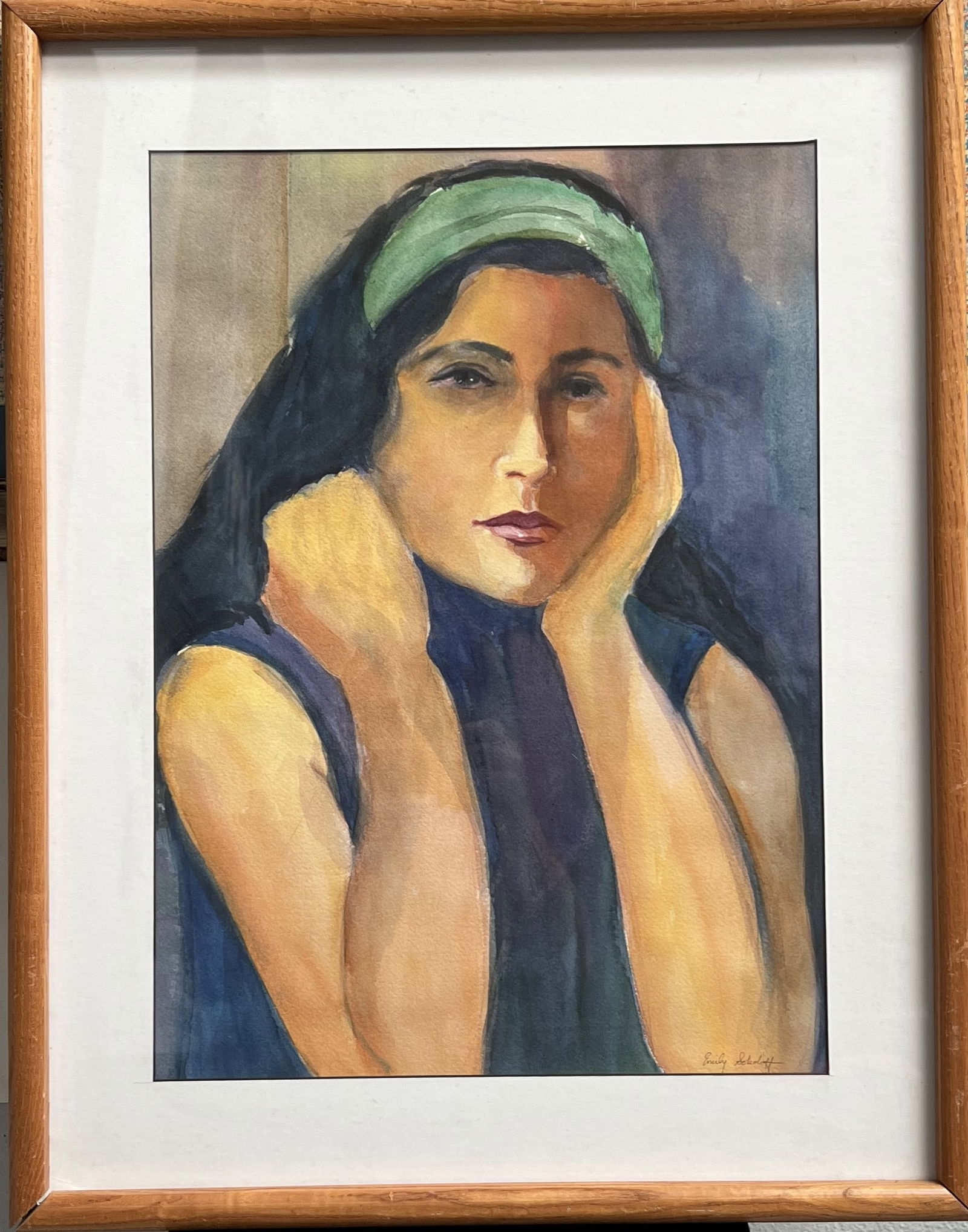Emily Sokoloff – Original Mid-Century Watercolor Portrait of a Woman: This expressive watercolor on paper captures a serene and pensive moment. The subject, a woman wearing a green headband and a dark sleeveless top, is rendered with soft, blended washes of color that e