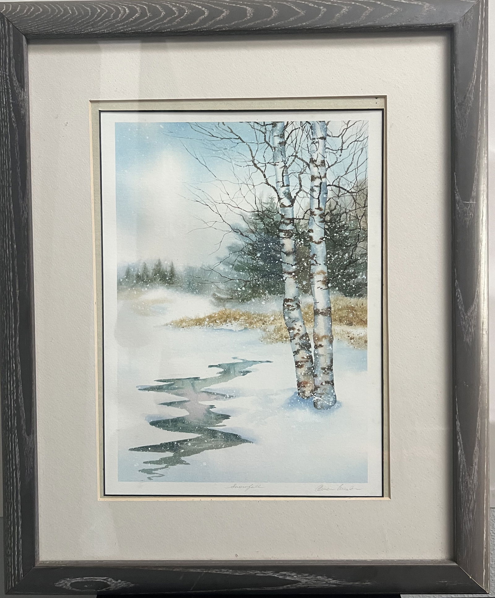 Owen Wexler Pencil-Signed Print "Snowfall" – Framed Winter Birch Landscape: This is a serene, pencil-signed watercolor-style print titled "Snowfall" by the artist Owen Wexler. Measuring 19 x 23 inches (framed), the piece captures a quiet, wintry landscape with the delicate to