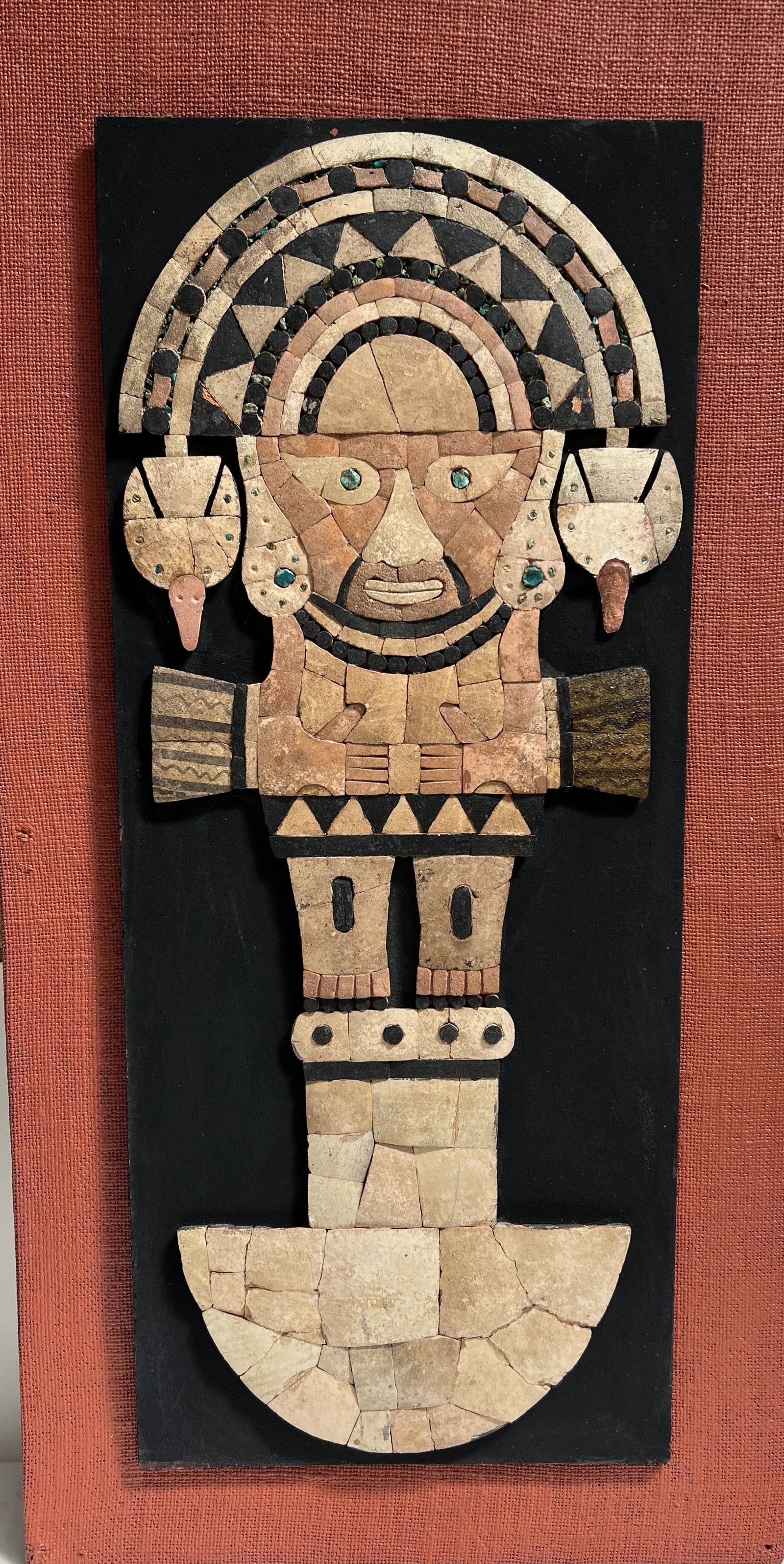 El Tumi The Ceremonial God-Knife of Peru: Medium: Hand-crafted stone and mineral mosaic. It features various shades of soapstone, marble, or alabaster tiles, with small turquoise-colored stone inlays for the eyes and jewelry.• Mounting: 