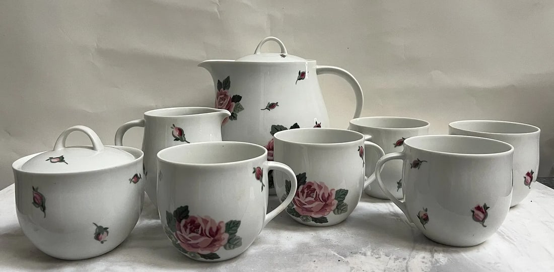 Vintage tea set with quite a pedigree in the world of 20th-century ceramic design.: That is a lovely vintage tea set with quite a pedigree in the world of 20th-century ceramic design.Based on the hallmark in your photos, this is the "Rose Garden" pattern from the Lyric line, produced