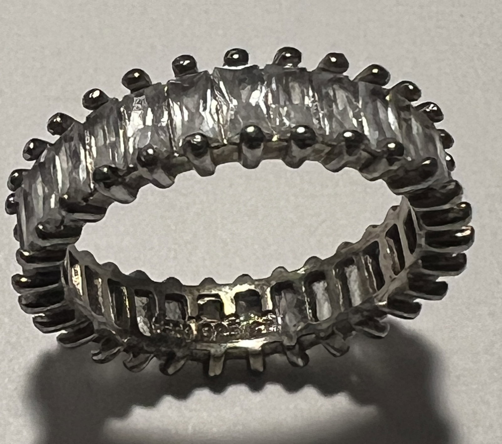 Sterling Silver 925 Emerald-Cut CZ Full Eternity Band Ring sz 7-8: Design Style: This is a full eternity band featuring vertically set emerald-cut or baguette-cut stones that wrap entirely around the band. The stones are held in place by shared prongs, creating a dis