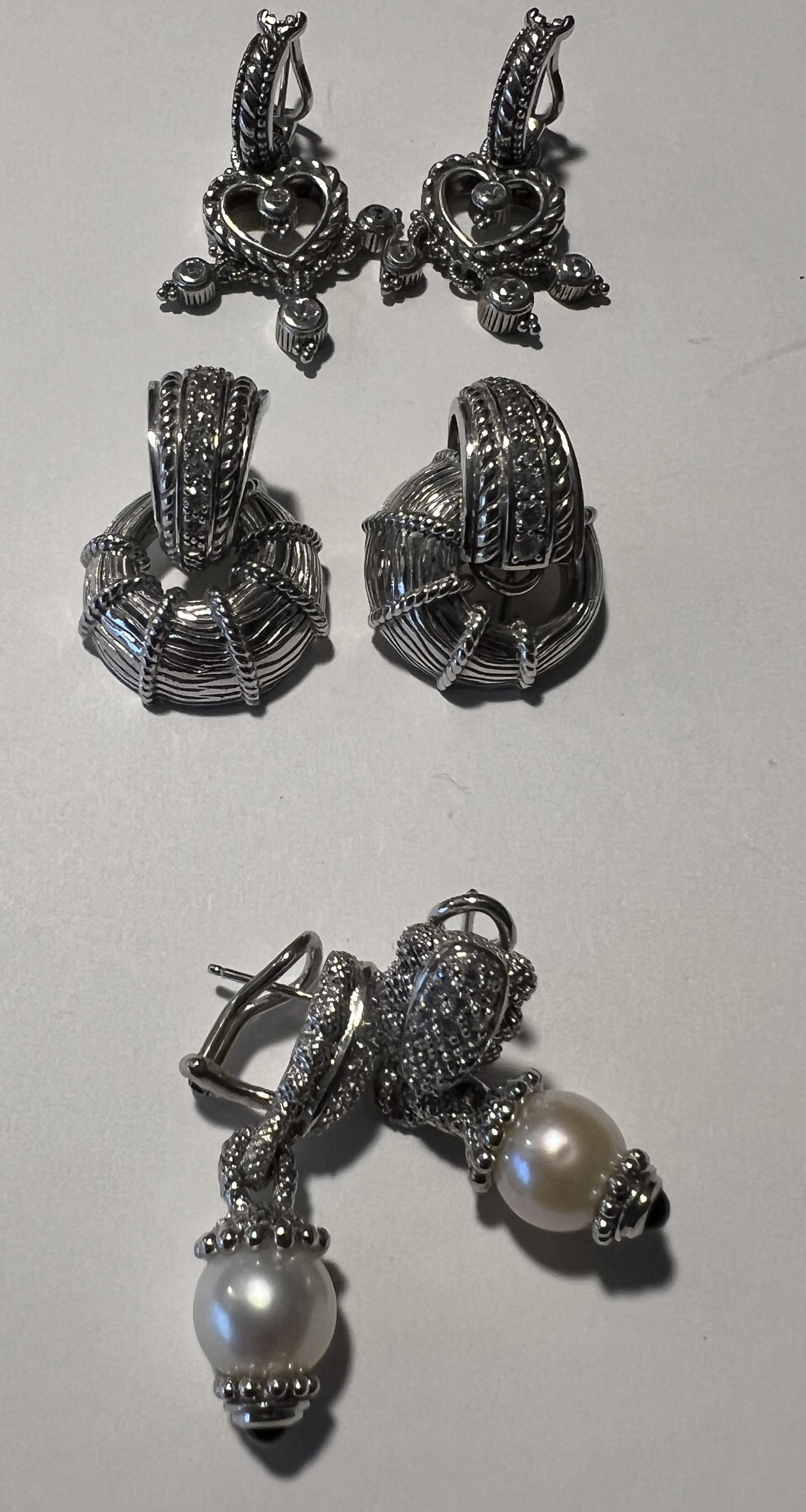 Lot of 3 Judith Ripka 925 Sterling Silver Earring Collection - Pearl, Heart, Door Knocker: Pair 1: Cultured Pearl & Diamonique Drop Earrings Design: As highlighted in , these elegant drop earrings feature a top section heavily encrusted with pavé cubic zirconia/diamonique stones on texturi