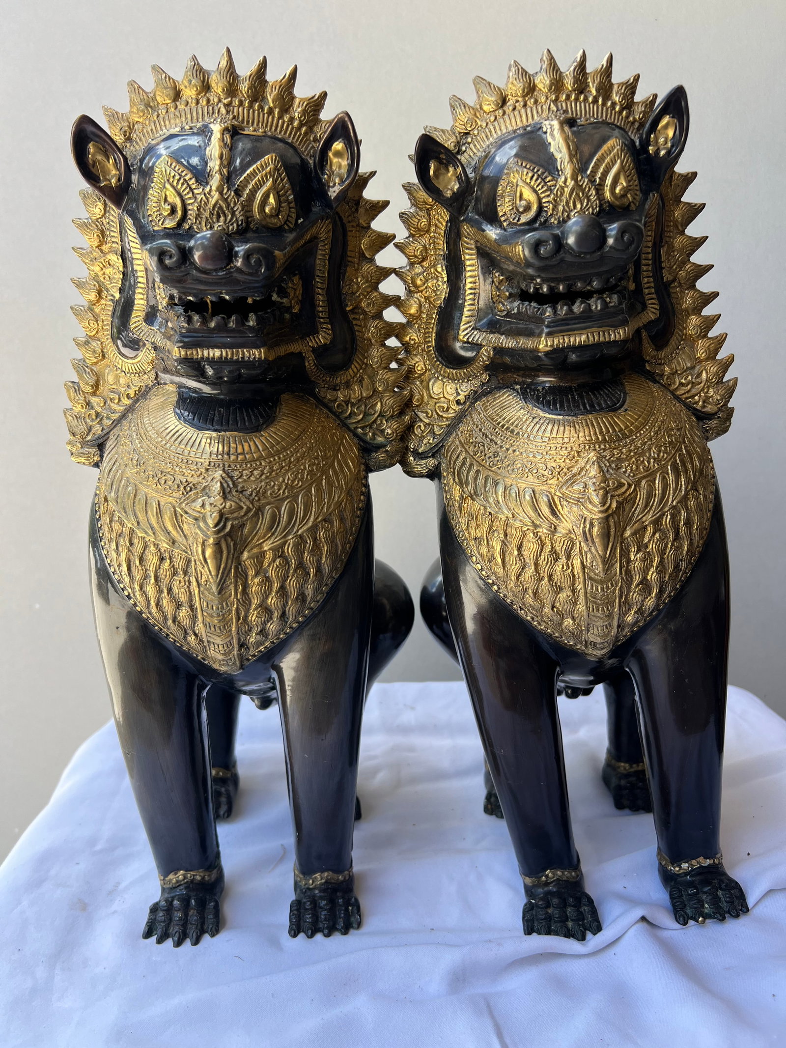 Pair of Vintage Southeast Asian Bronze Singha Temple Guardian Lion Statues - 16”: Item Overview Item: Pair of Mythical Singha (Temple Guardian) Lions Material: Cast Bronze with Detailed Gilt/Polished Accents Dimensions: Approx. 16” H x 8” W (each) Condition: Excellent v