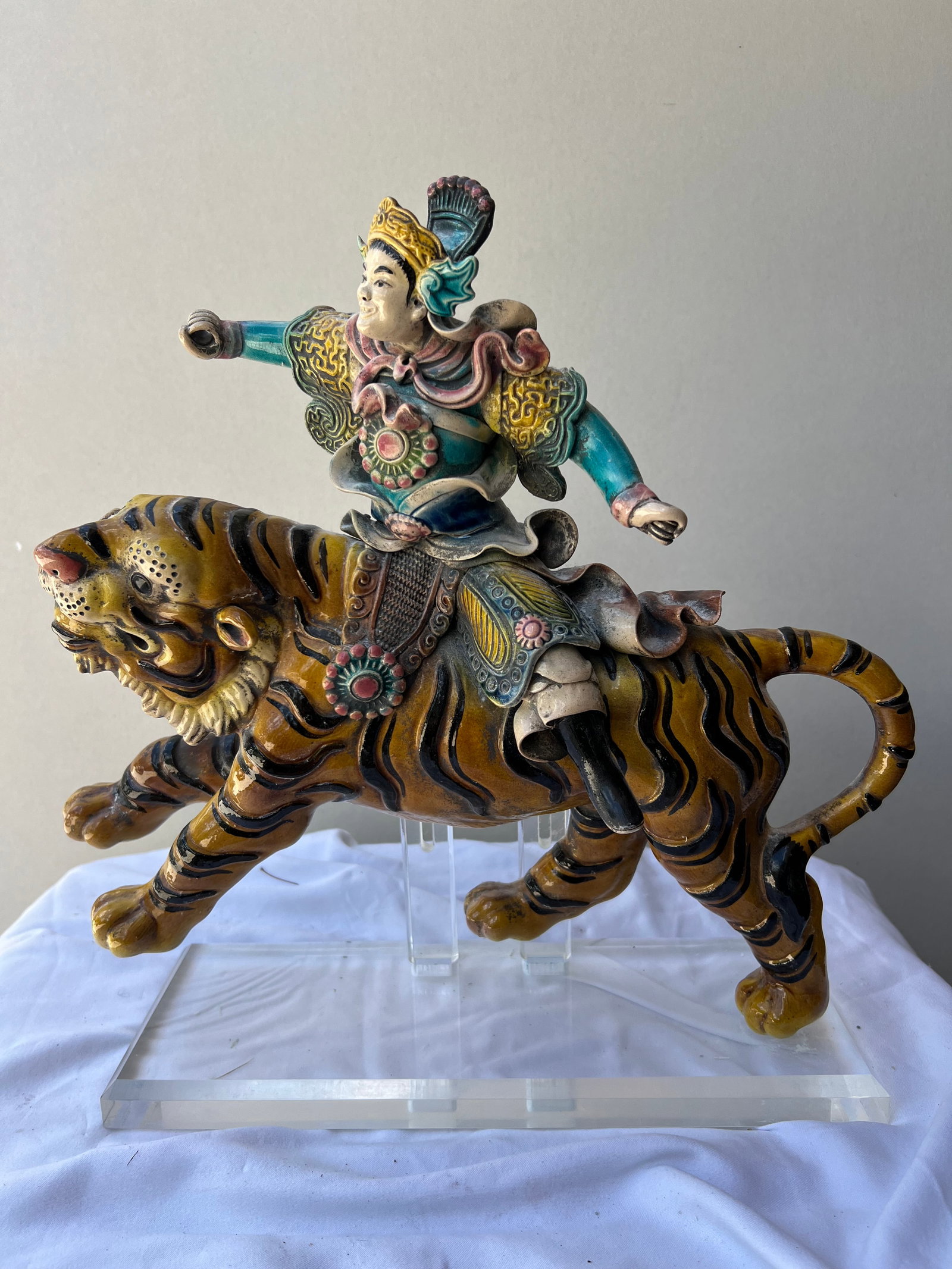 Zhao Gongming, the Martial God of Wealth, Taming the Black Tiger" (Alternative Title: Martial Wealth: Zhao Gongming, the Martial God of Wealth, Taming the Black Tiger" (Alternative Title: Martial Wealth God Zhao Gongming)Iconography & NarrativeThis dynamic ceramic figure depicts Zhao Gongming , one of