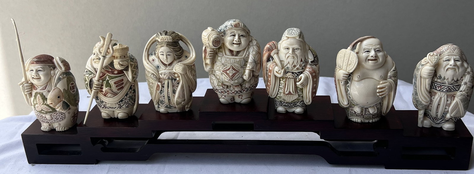 Complete Set of Japanese Carved Netsuke/Okimono Style Figures – The Seven Lucky Gods: Complete Set of Japanese Carved Netsuke/Okimono Style Figures – The Seven Lucky Gods (Shichifukujin)DescriptionThis is a beautifully detailed, complete set of seven Japanese carved miniature figures