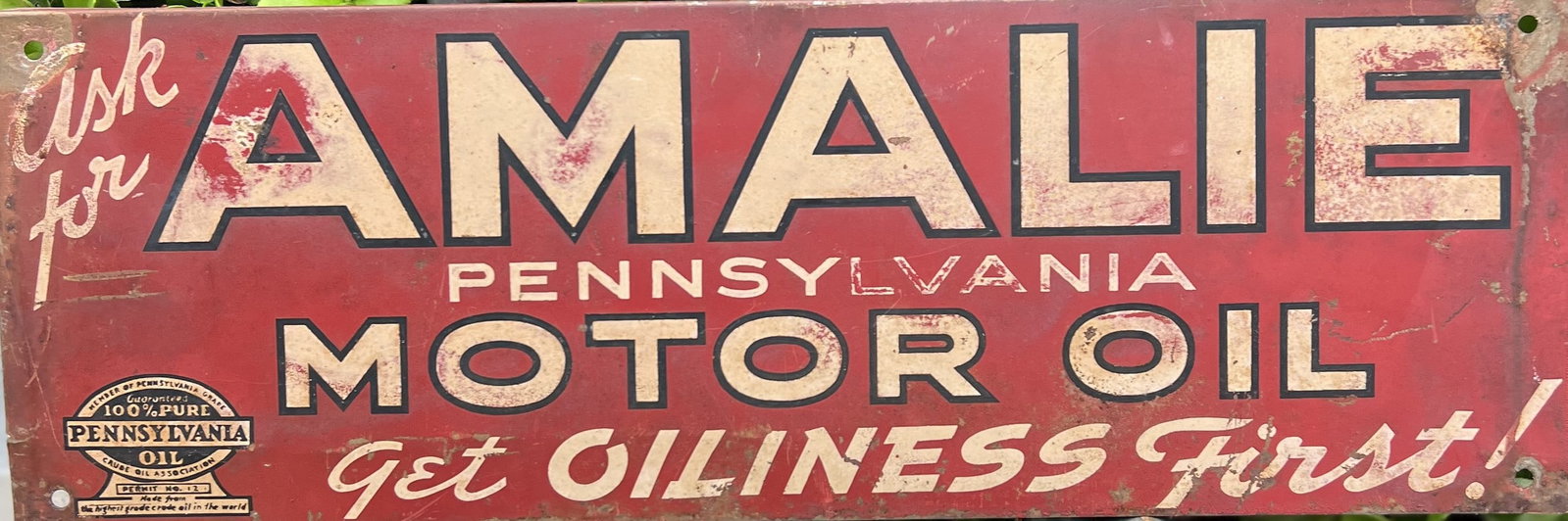 Vintage Amalie Motor Oil Sign: Vintage Amalie Motor Oil SignThis is a vintage, rectangular metal advertising sign for Amalie Pennsylvania Motor Oil. Description: The sign features a red background with a prominent, stylized cream-c