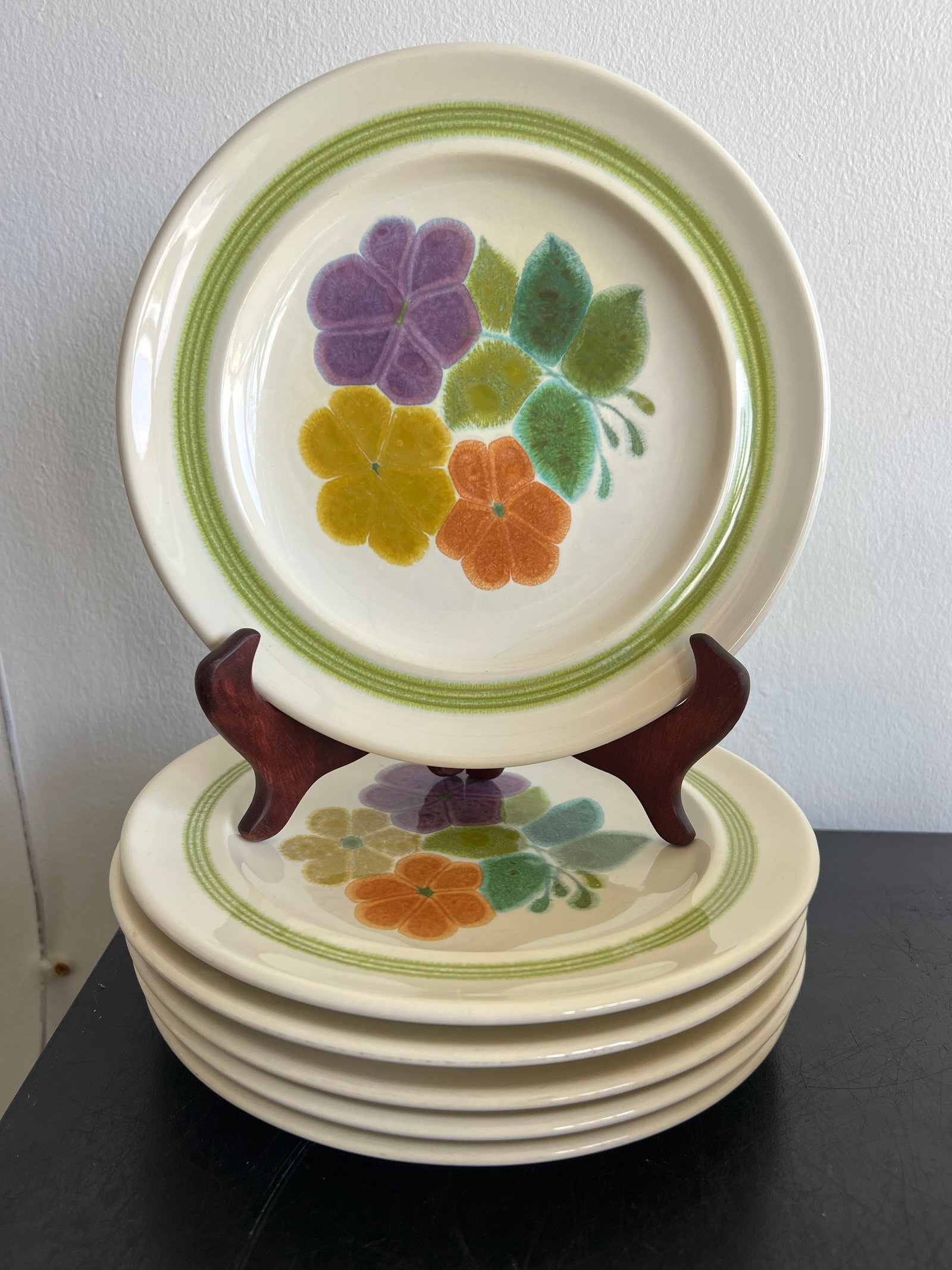 Vintage Mid-Century Floral Stoneware Plates – Set of 6 (9-Inch): This set of six 9-inch ceramic stoneware salad/dessert plates features a charming retro floral motif in soft watercolor shades of purple, mustard yellow, orange, and muted green. Each off-white plate 