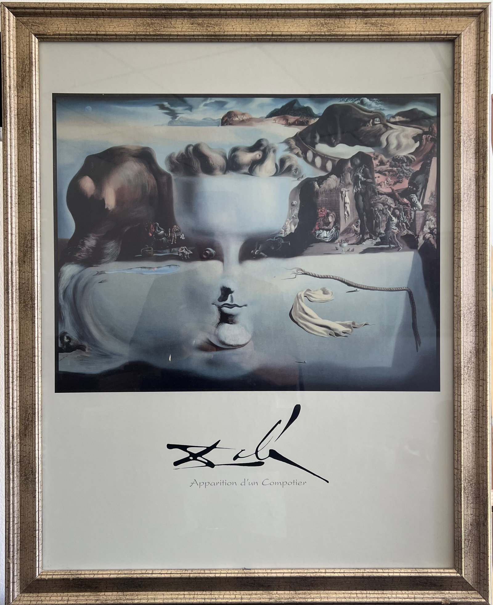 Salvador Dali Apparition d'un Compotier Framed Art Print 25x31 Surrealist Wall Art: Art DescriptionThis piece is a framed art print featuring Salvador Dalí’s iconic 1938 Surrealist masterpiece, Apparition of Face and Fruit Dish on a Beach (Apparition d'un Compotier).The artwork ut