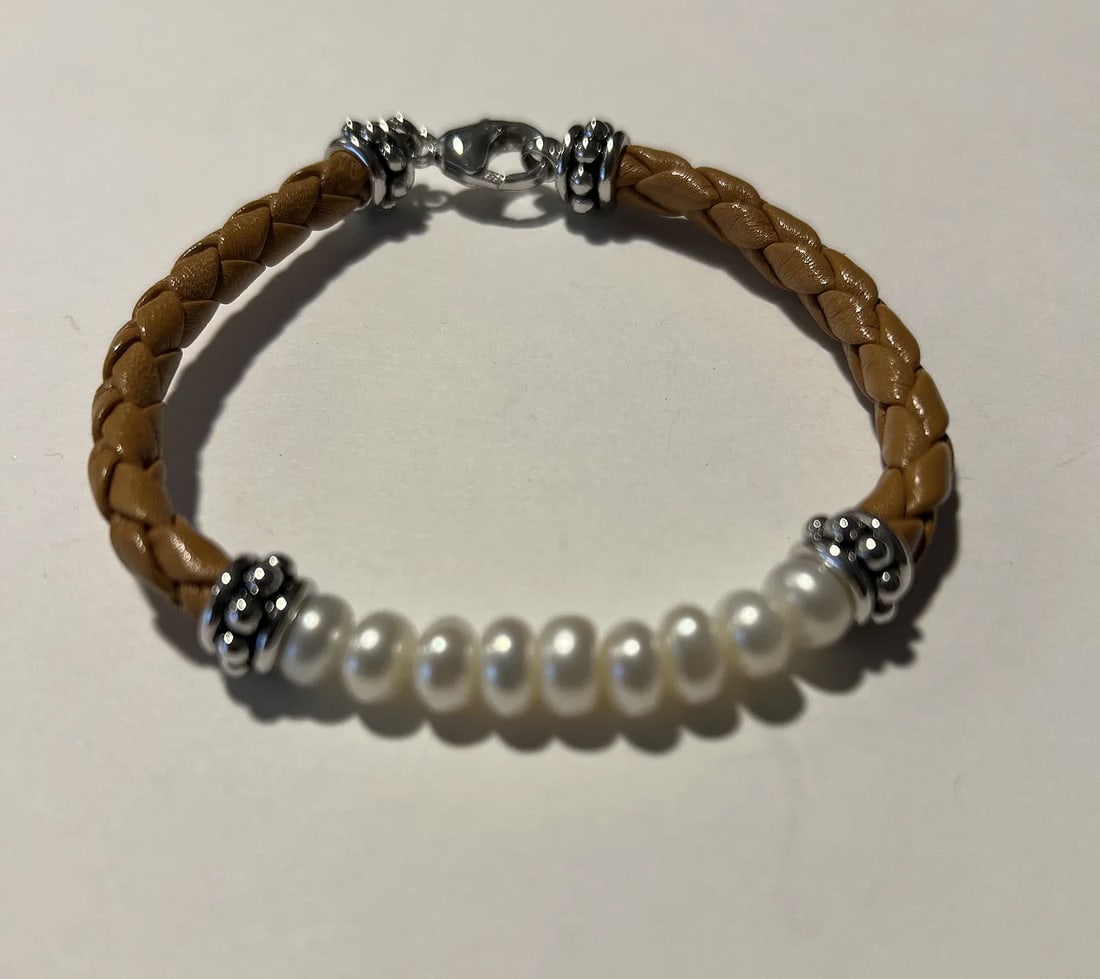Boho White Freshwater Cultured Pearl Tan Braided Leather Cord Bracelet: This is a handsome, artisan-style mixed-media bohemian strand bracelet blending organic textures with polished elements.Item Description Design & Materials: the bracelet features a partial strand of a