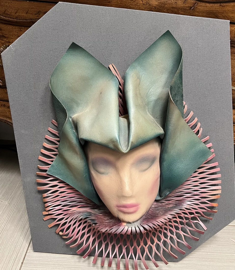 Vintage Mixed Media Sculpture Featuring a bust of a Women: This is a vintage, mixed-media sculpture featuring a bust of a woman's face. Subject: The central element is a small, realistic-looking bust of a woman's face with a neutral expression and pink lips. 