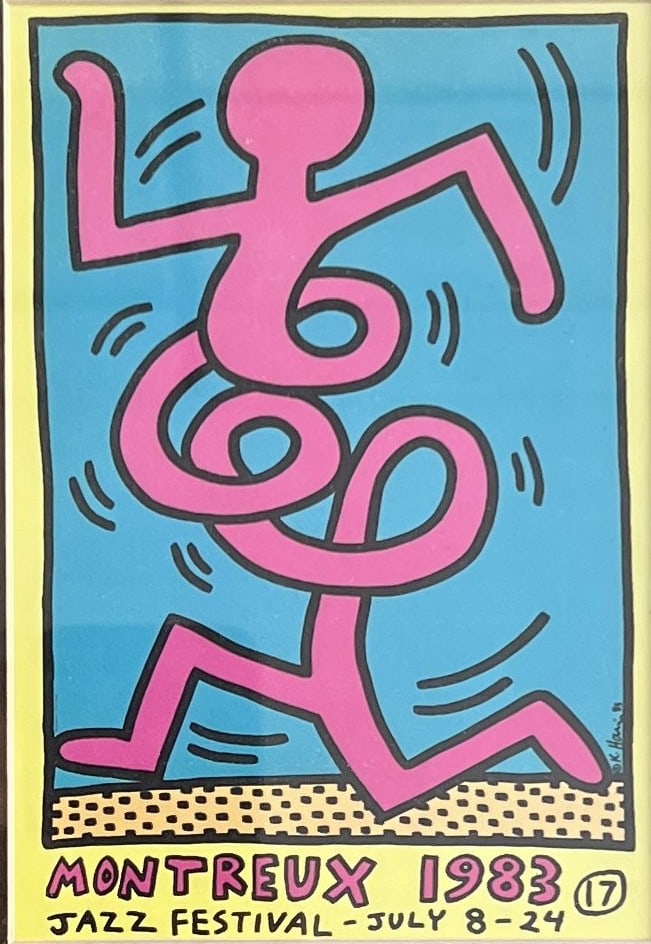 This framed piece features Keith Haring’s iconic design for the 1983 Montreux Jazz Festival (July: This framed piece features Keith Haring’s iconic design for the 1983 Montreux Jazz Festival (July 8–24, 1983). Front: Depicts a stylized pink dancing figure set against a light blue background wit