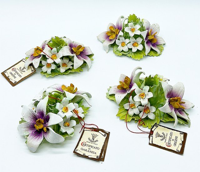Set of 4 - 1960s Capodimaye flower candlestick holders.: Set of 4 - 1960s Capodimaye flower candlestick holders. Each holds one tapper style candle. Each one is stamped and they have their original tags from Italy. Approx 3 tall x 7 x 5.5