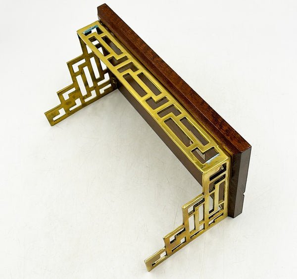 80s vintage brass fretwork style wall shelf bracket with wooden stained top with plate groove: 80s vintage brass fretwork style wall shelf bracket with wooden stained top with plate groove. Stamped decorative crafts. Approx 6 tall x 12.5 wide x 6.5 deep x projection from the wall.