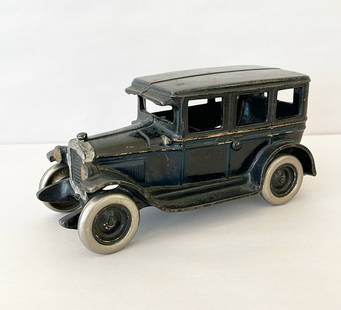 Cast iron model T car made by Arcade manufacturing.: Cast iron model T car made by Arcade manufacturing. Heavy piece. Some paint flaking off. Wheels rotate. Approx 4 tall x 8x 4.