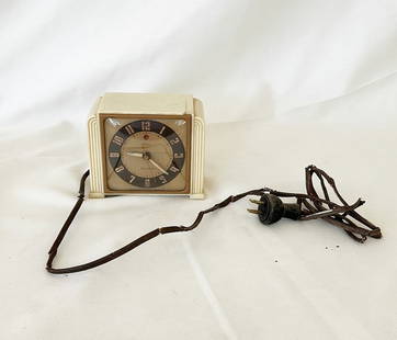 Vintage art deco style alarm clock made by TELECHRON.: Vintage art deco style alarm clock made by TELECHRON. Electric but not working as shown from the rotted electric cord. Minor crack on top as shown. Approx 4 tall x 5 wide x 2.5 deep.