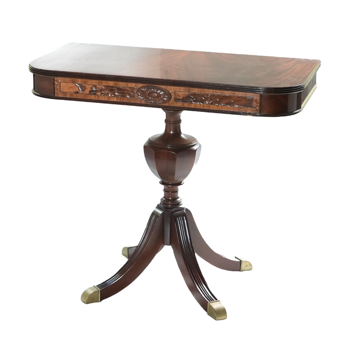 Mahogany Console Table: Early 20th Century Mahogany Console Table with front table inlay, a single urn shaped pedastal base with 4 brass capped feet on reeded legs.