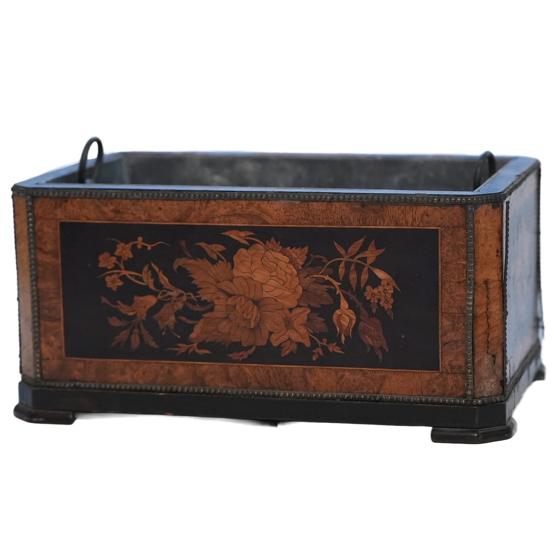 English Burled and Ebonized Wood Jardiniere: An English burled and ebonized wood jardiniere having a rectangular chamfered shape with dutch inspired marquetry floral pattern on four panels, the whole with brass beading. Mid 19th century. Purchas