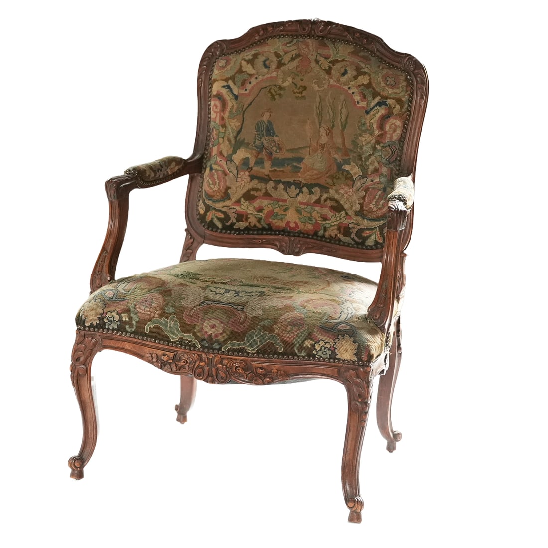 Upholstered Louis XV Style Arm Chair: A Louis XV style beechwood fauteuil chair with a cartouche shaped backrest with foliate carving and padded arms on carved arm supports. Serpentine fronted seat with a foliate carved rail, raised on ca