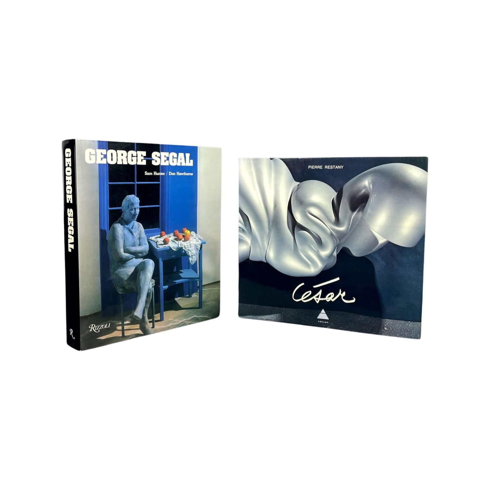 CESAR (SIGNED) AND GEORGE SEGAL (SIGNED) ABRAMS BOOKS. 2 BOOKS SOLD TOGETHER: [ARTIST MONOGRAPH] TWO ARTISTS' SIGNED MONOGRAPHS SOLD TOGETHER. 1.) CESAR. Boldly Signed and dated with blue ballpen on the front endpaper. Text by Pierre Reastany. Published by Abrams, NY, 1976. Obl
