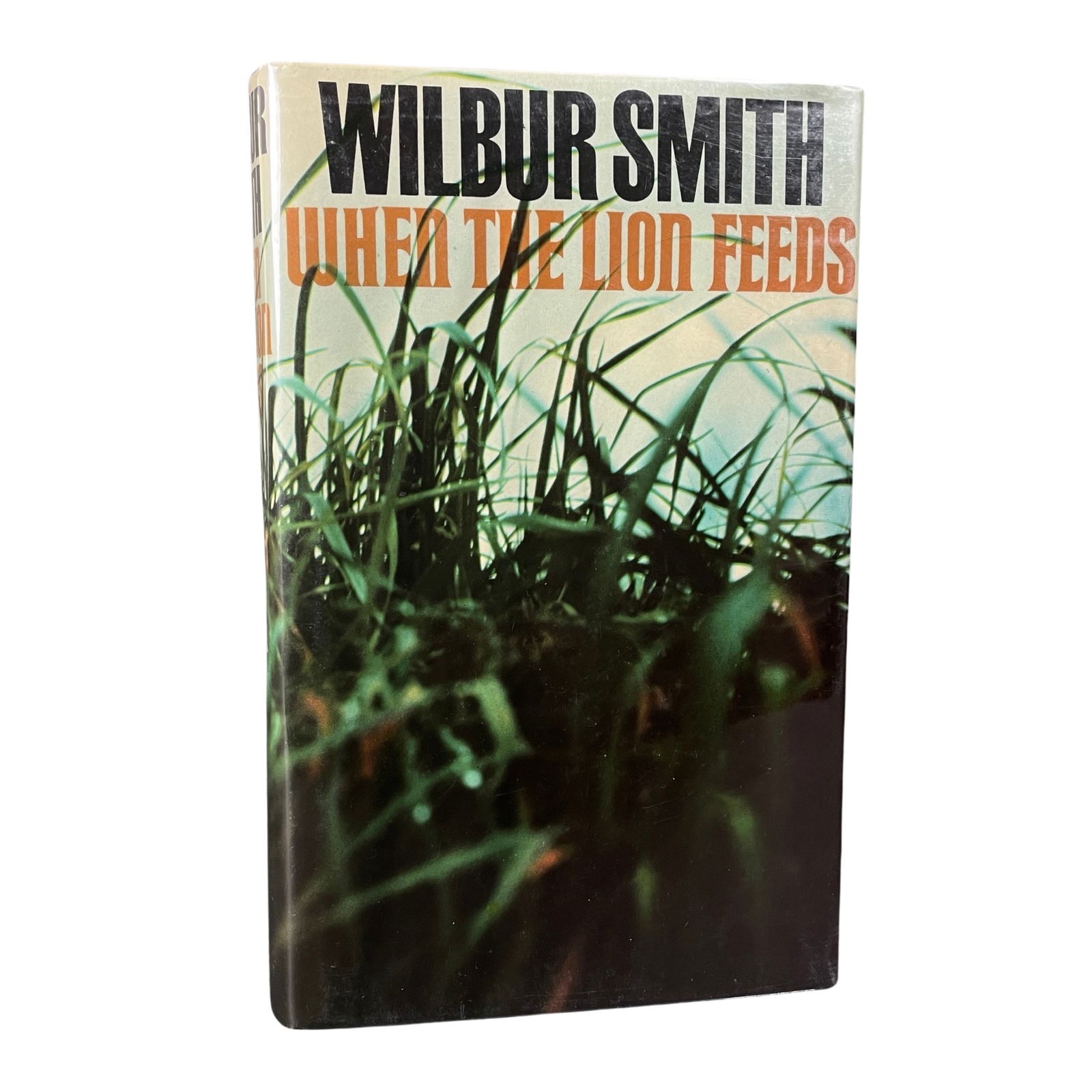 SIGNED. WILBUR SMITH: WHEN THE LION FEEDS. 1986. 1ST ED. (1 of 4)
