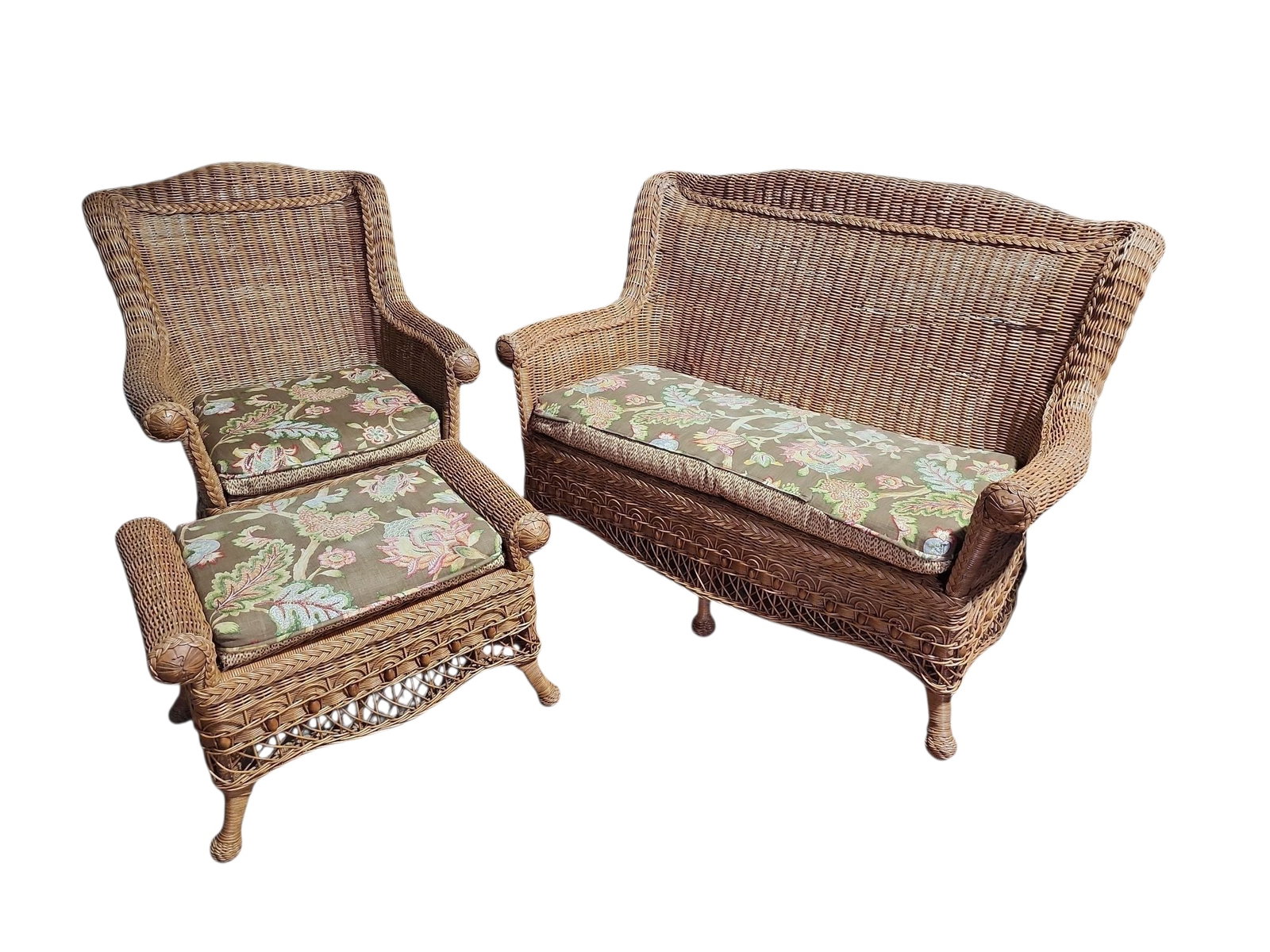 1920s Victorian Wicker and Rattan Parlor Suite- 3 Pieces: Gorgeous Victorian era wicker and rattan parlor suite, consisting of settee, chair, and ottoman, all in exellent condition.Reversable cushions, floral to one side, geometric pattern to other, included