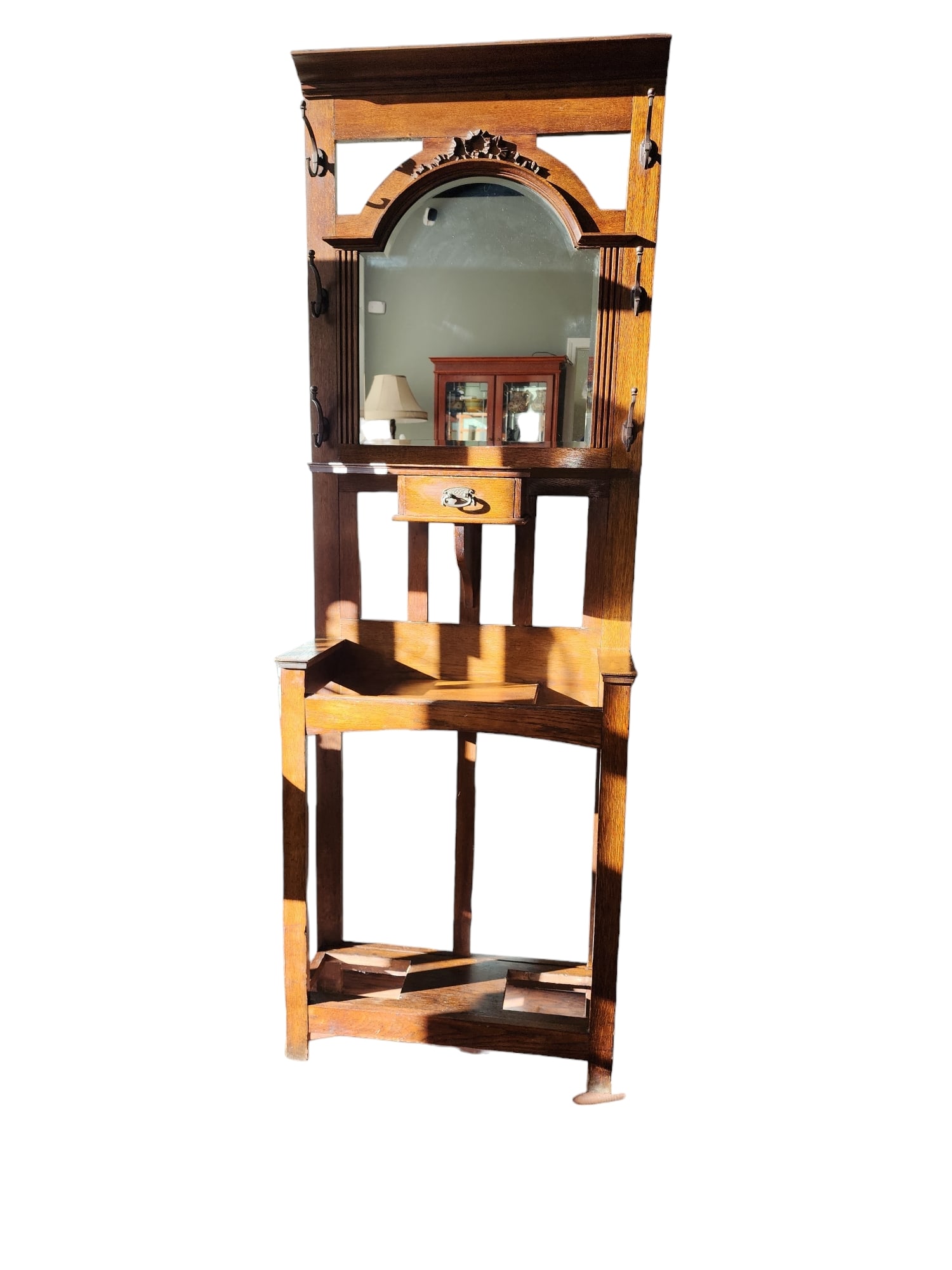 1920s English Edwardian Mirrored Hall Stand: Beautiful 1930s English Edwardian, double shelved, solid oak hall stand with central beveled mirror, central glove drawer, pierced umbrella or cane holders, and original bronze hardware. Lovely muted