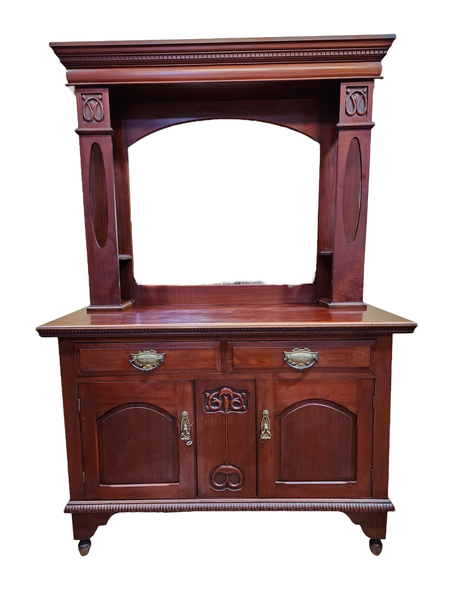 1900s Arts & Crafts Mahogany Mirror Backed Sideboard: Superb English Arts & Crafts mahogany mirror-backed sideboard in excellent condition. Absolutely beautiful as is, would also make a fantastic bar feature. Ornate carvings and unique upper shelves behi