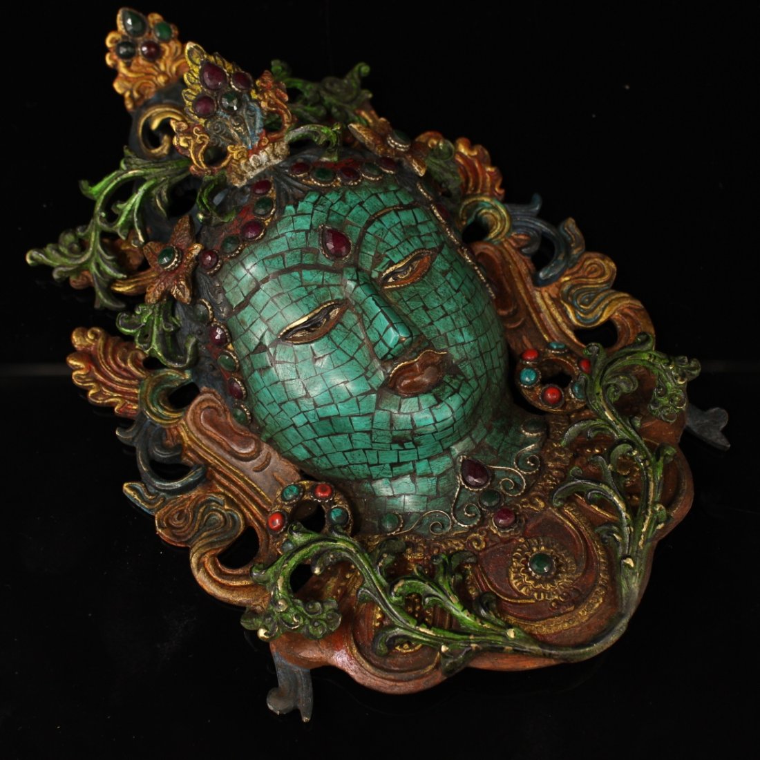 Gemstone painting depicting gold and green Tara head mask (1 of 6)