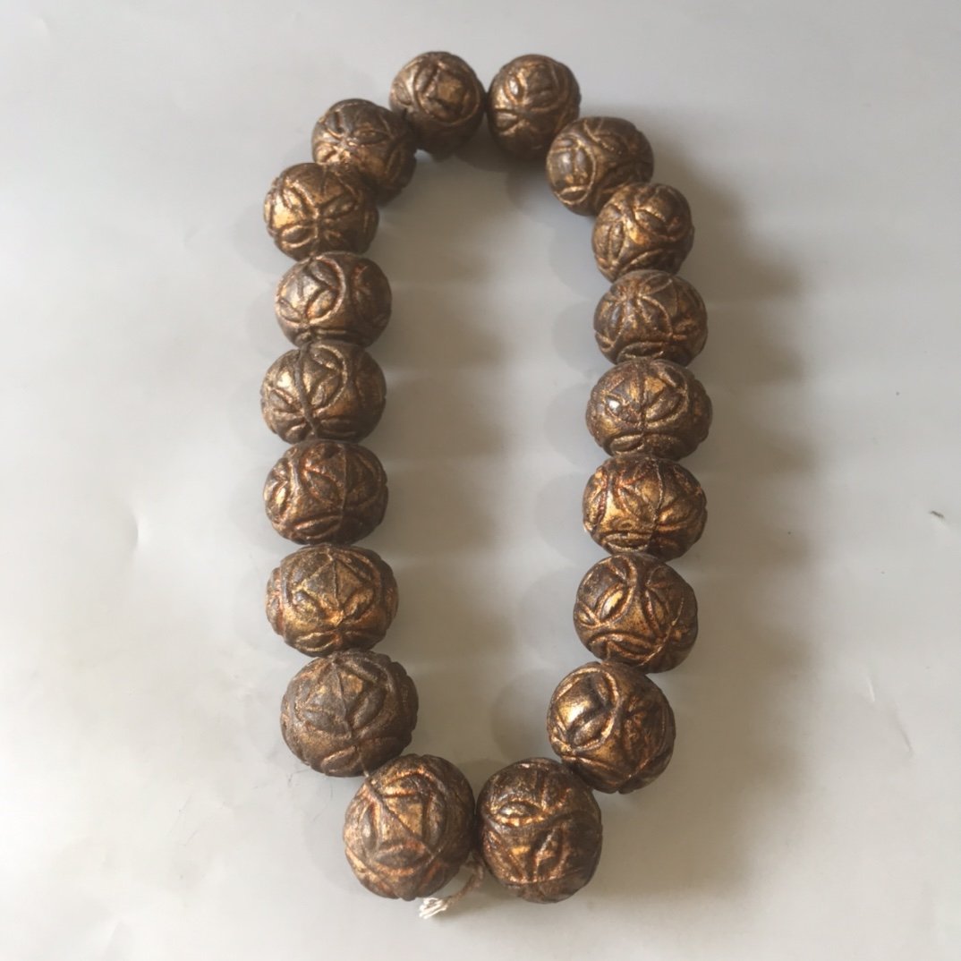 Qing Dynasty: Eighteen gold-sealed agarwood coins held in hands (1 of 10)