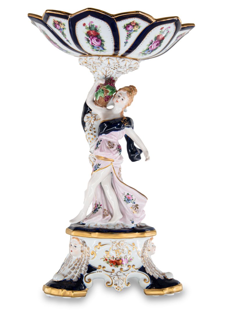 Porcelain Serving Bowl With Grape Motif: Up for auction is a beautiful porcelain serving bowl. The bowl sits on a Rococo style porcelain figure of a woman and is completely hand painted. The dark blue color of the jar is striking and elegant