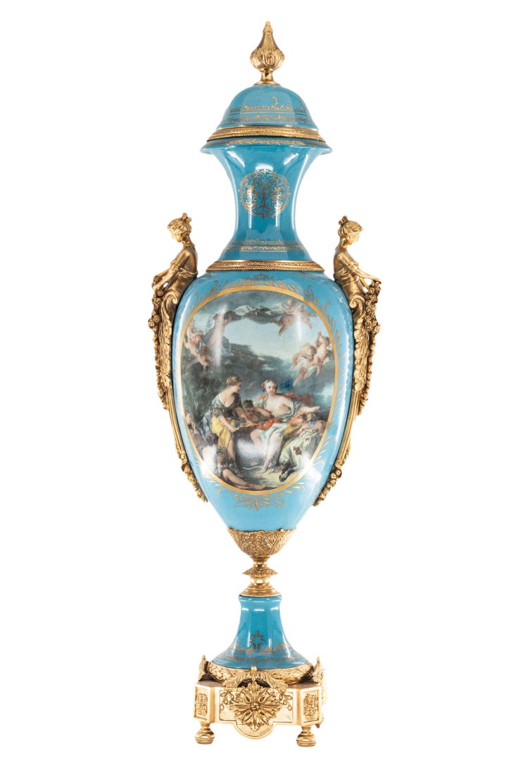 Striking Porcelain and Bronze Cherub Vase: Up for auction is an exceptional porcelain vase. The vaseâ€™s body sits on top of a flared stem, and a bronze square base. This piece is highlighted by the incredibly detailed bronze handles exem
