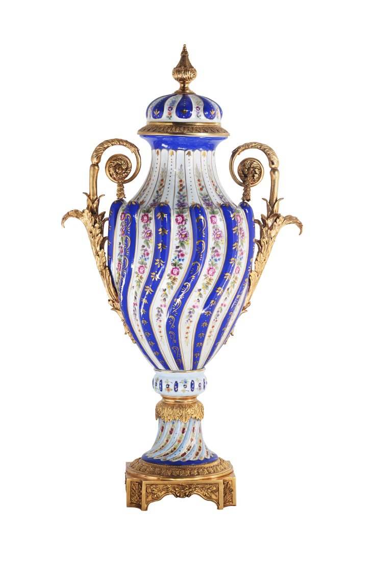 Twisted Porcelain and Bronze Vase: Up for auction is an exceptional porcelain lidded vase. The vaseâ€™s body sits on top of a flared stem, and an ornate square bronze base. This piece is highlighted by the incredibly detailed bron