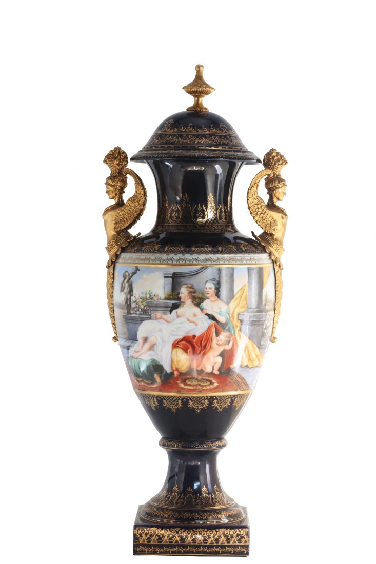 Rococo Style Bronze and Porcelain Vase: Up for auction is an exceptional porcelain vase. The vaseâ€™s body sits on top of a flared stem, and a square base. This piece is highlighted by the incredibly detailed bronze handles depicting f