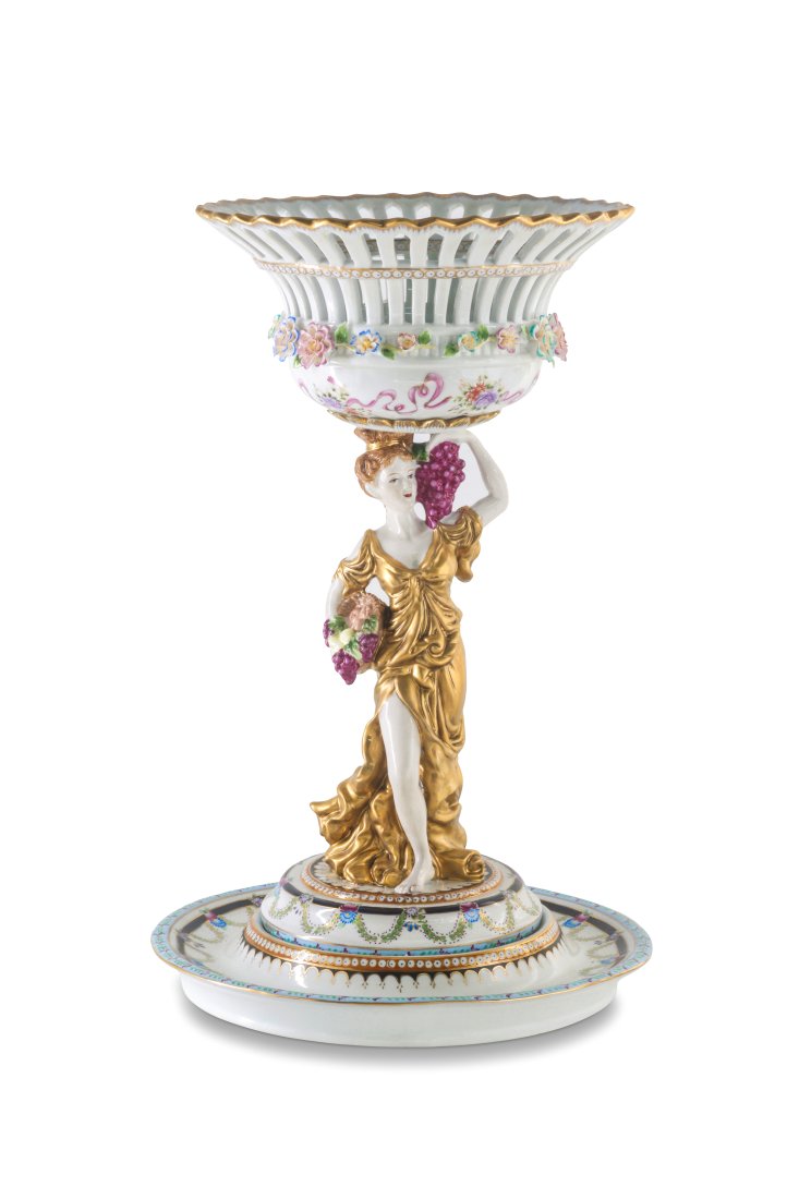 Hand Painted Porcelain Serving Bowl: Up for auction is a beautiful porcelain serving bowl. The bowl sits on a Rococo style porcelain figures of a woman and is completely hand painted. The orange color of the bowl is striking and elegant,