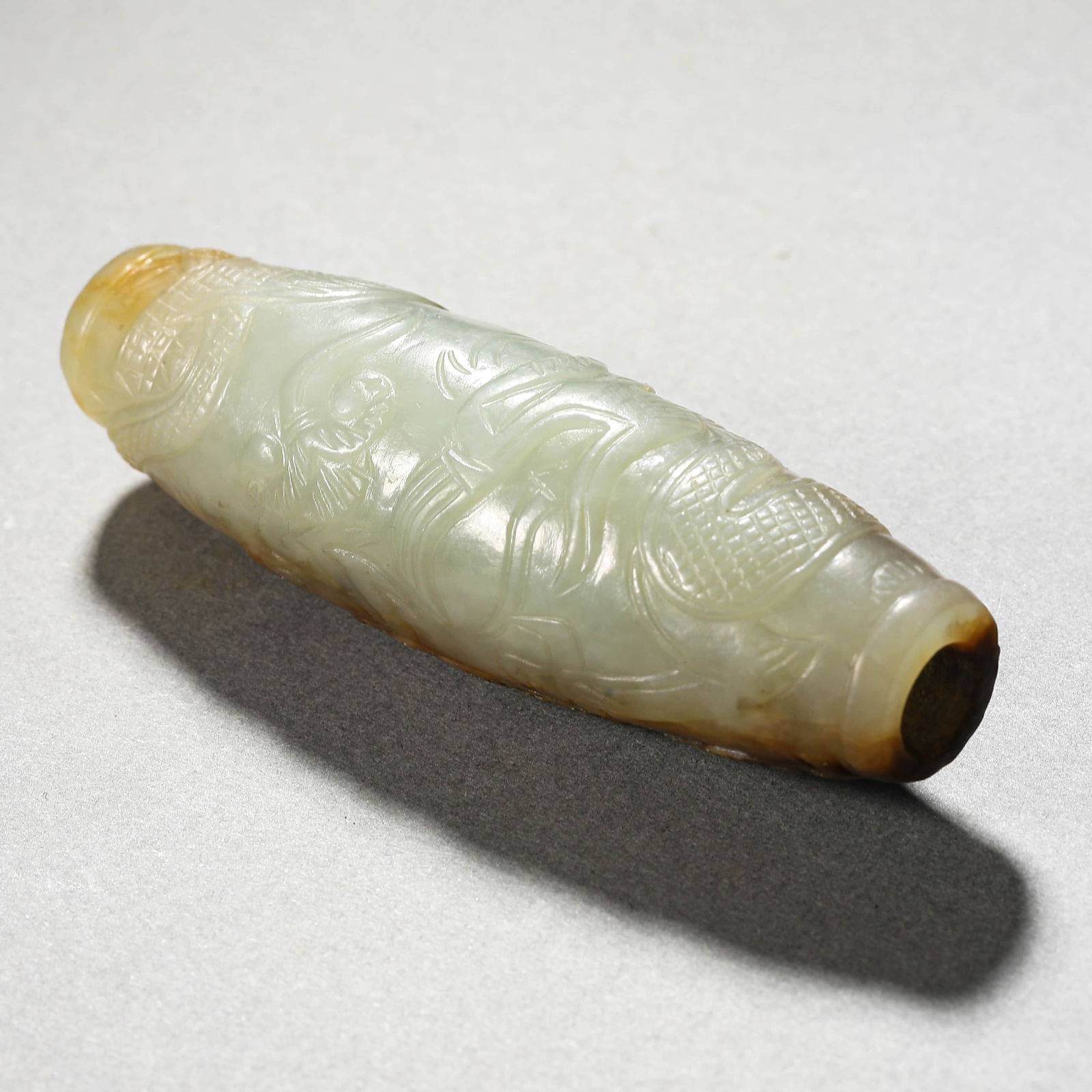 A CHINESE JADE BEAD WITH ANIMAL MOTIFS.: A CHINESE JADE BEAD WITH ANIMAL MOTIFS. Dimensions: Length: 2 13/16 in. (7.2 cm) ALL ITEMS SOLD AS IS, NO RETURNS Condition: Any statement made in any catalogue or otherwise regarding the
