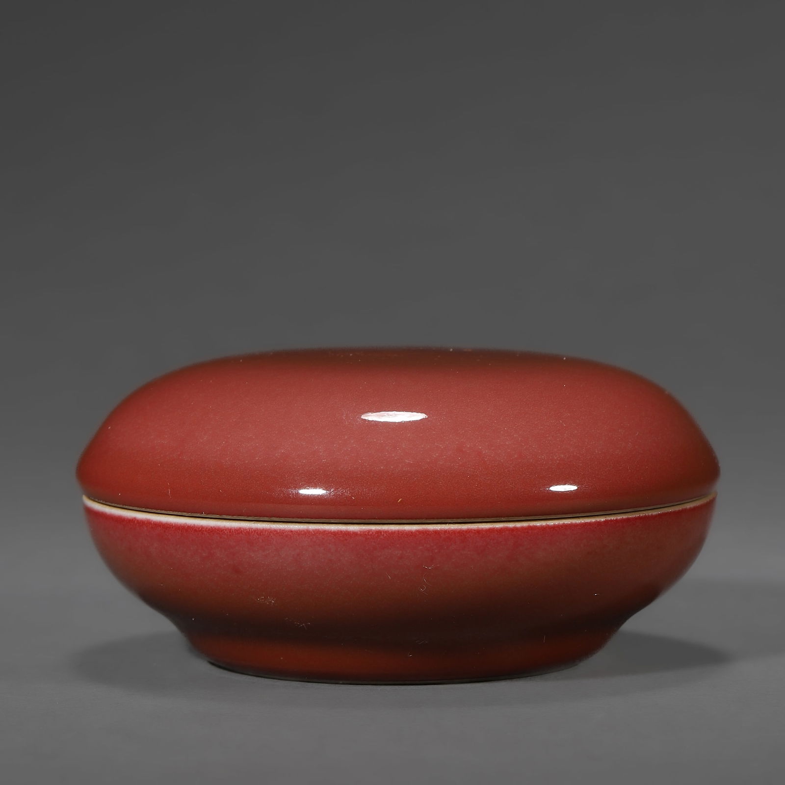 A CHINESE RED-GLAZED SEAL PASTE BOX. (1 of 2)