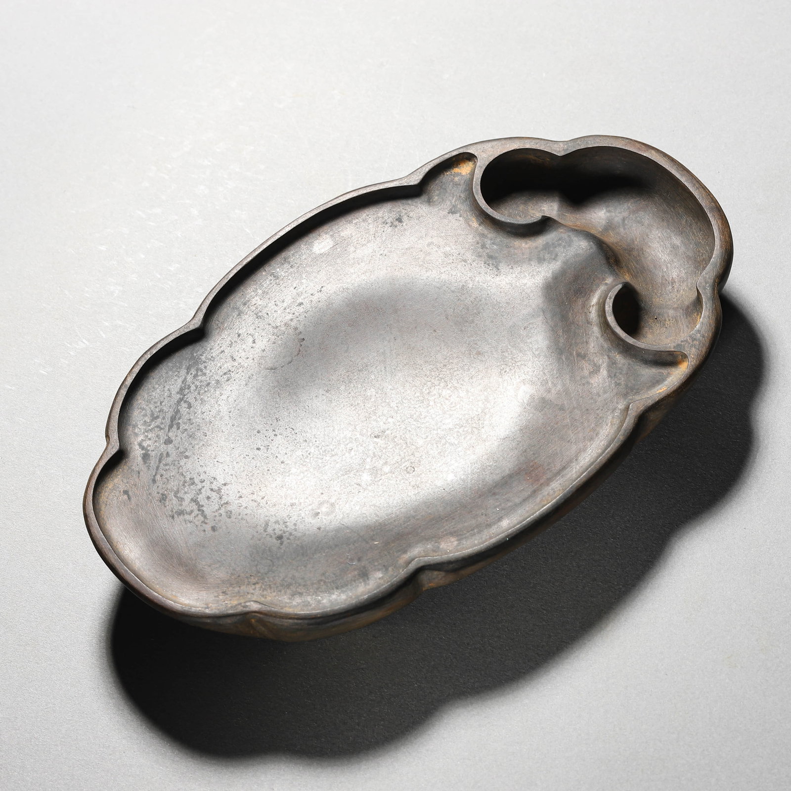 A CHINESE INKSTONE WITH CLOUD MOTIFS BY WANG YAN. (1 of 3)