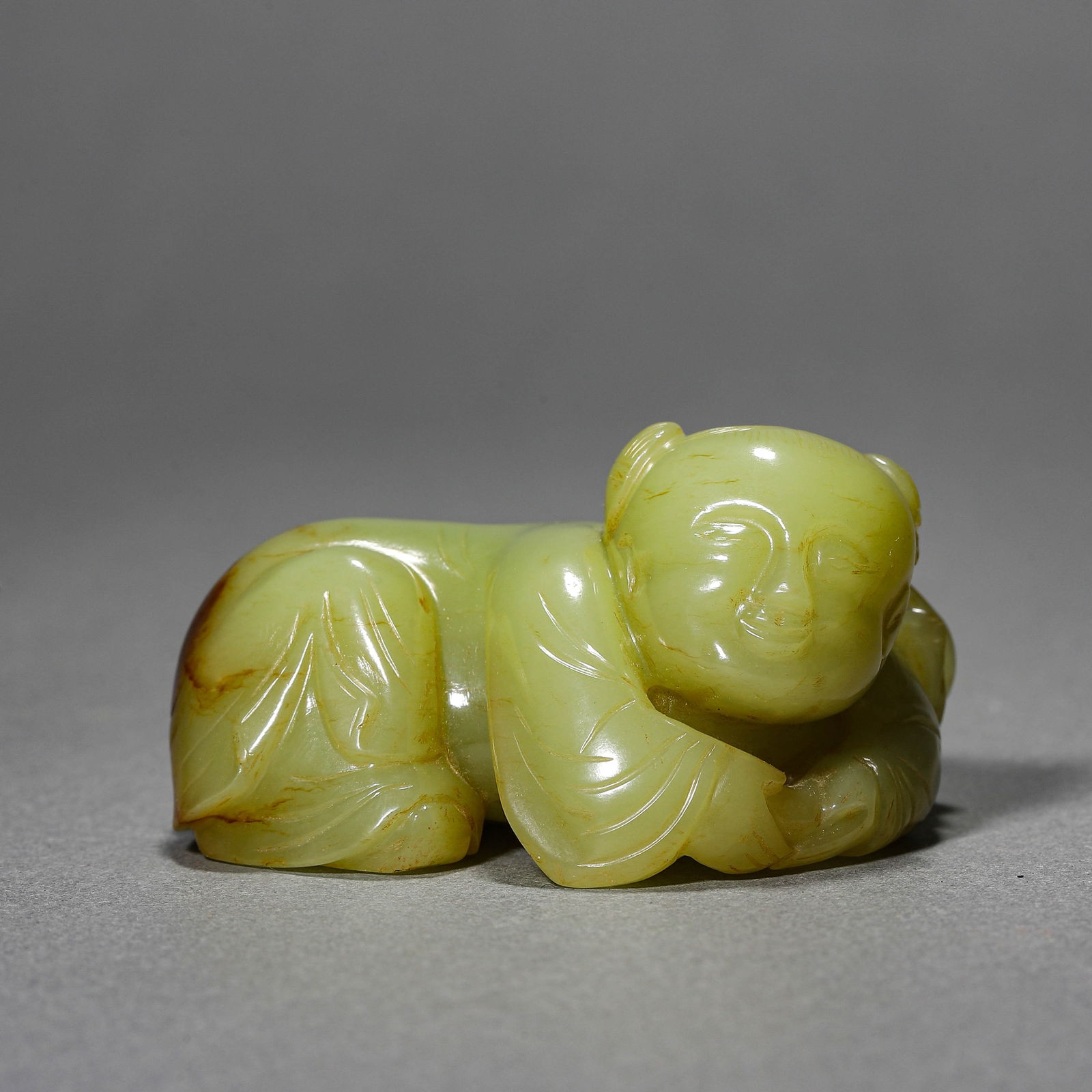 A CHINESE YELLOW JADE "BOY" FIGURINE. (1 of 3)