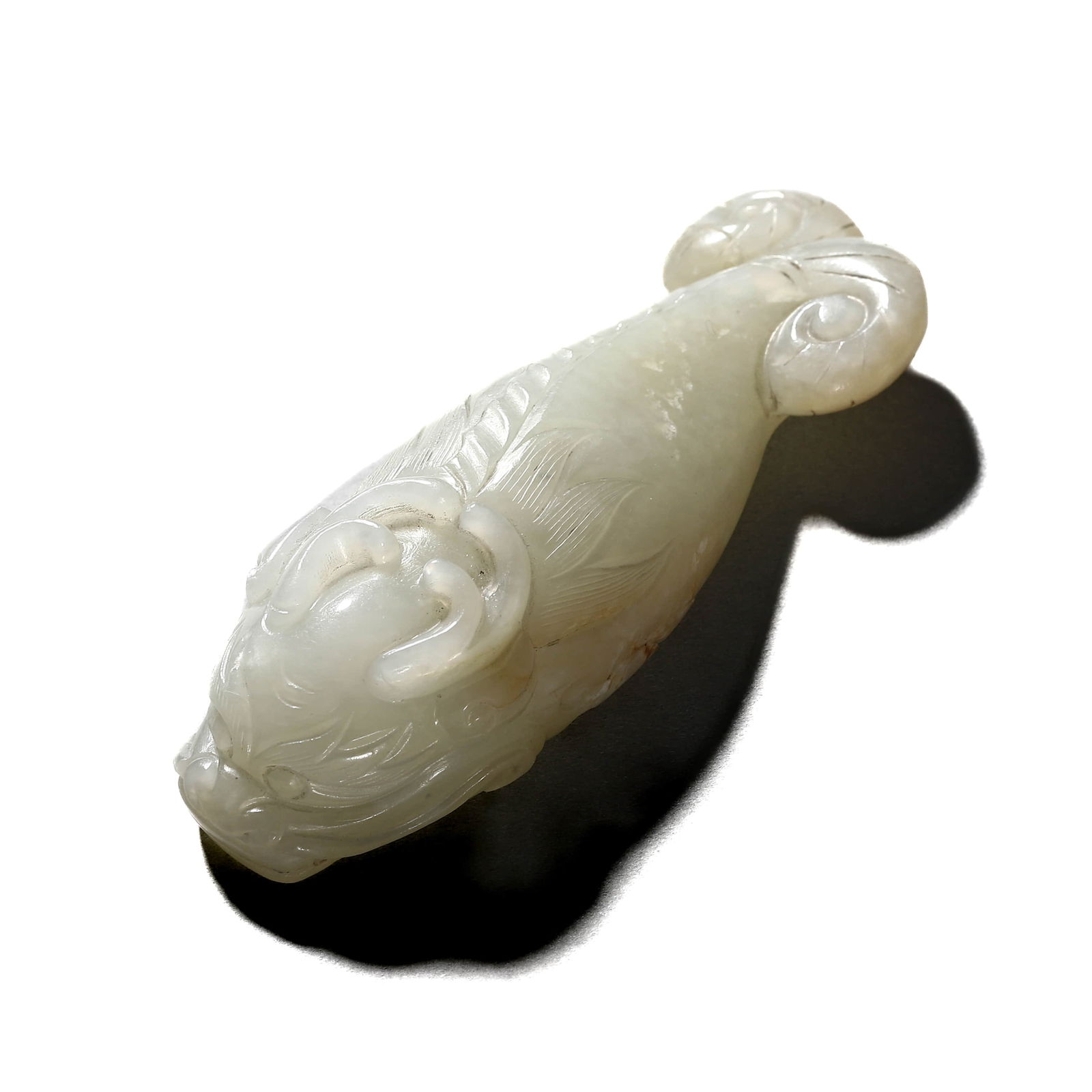A CHINESE WHITE JADE 'FISH-TRANSFORMING-TO-DRAGON' PENDANT. (1 of 3)