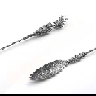 ART NOUVEAU ANTIQUE SILVER SPOON: An intricately designed Art Nouveau (1880–1920) antique silver spoon featuring a highly detailed relief of a cherub resting among swirling clouds on the bowl. The twisted handle is adorned with a sc