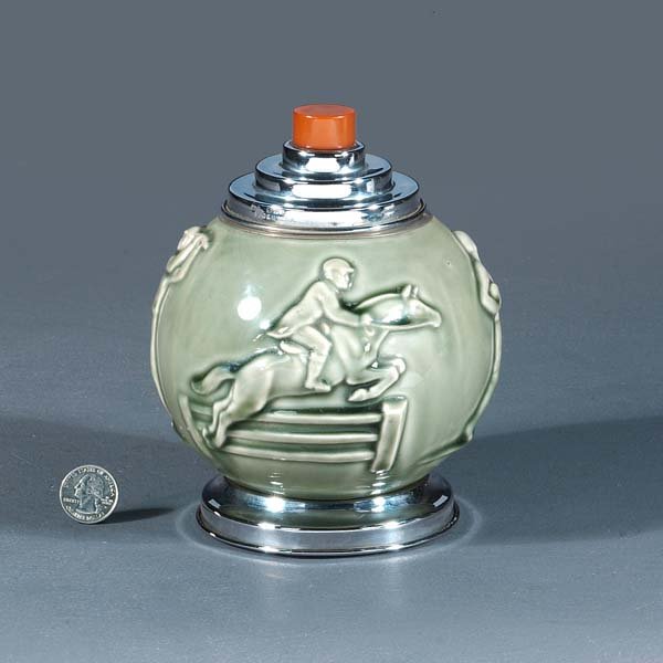 Rookwood pottery, sporting cigarette dispenser wit: Rookwood pottery, sporting cigarette dispenser with pale green glazing and images of golfing, football, fishing and riding, 5" wide, 5" deep, 6 3/4" tall.