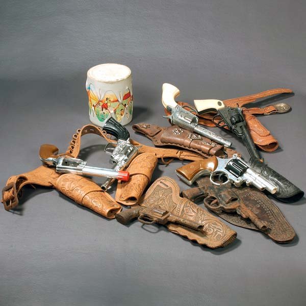Vintage toy cowboy guns and holster sets, a toy in: Vintage toy cowboy guns and holster sets, a toy indian drum and a box of collectable hard plastic toy horses, indians and cowboys.