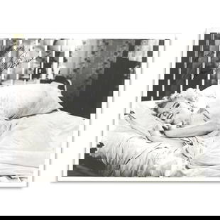 MARILYN MONROE SIGNED BLACK-AND-WHITE PHOTOGRAPH: 25.8 x 20 cm (10 1/8 x 7 7/8 in) This lot features an original black-and-white photograph of Marilyn Monroe, personally signed and inscribed with the affectionate message "Love & Kisses." Depicting Mo
