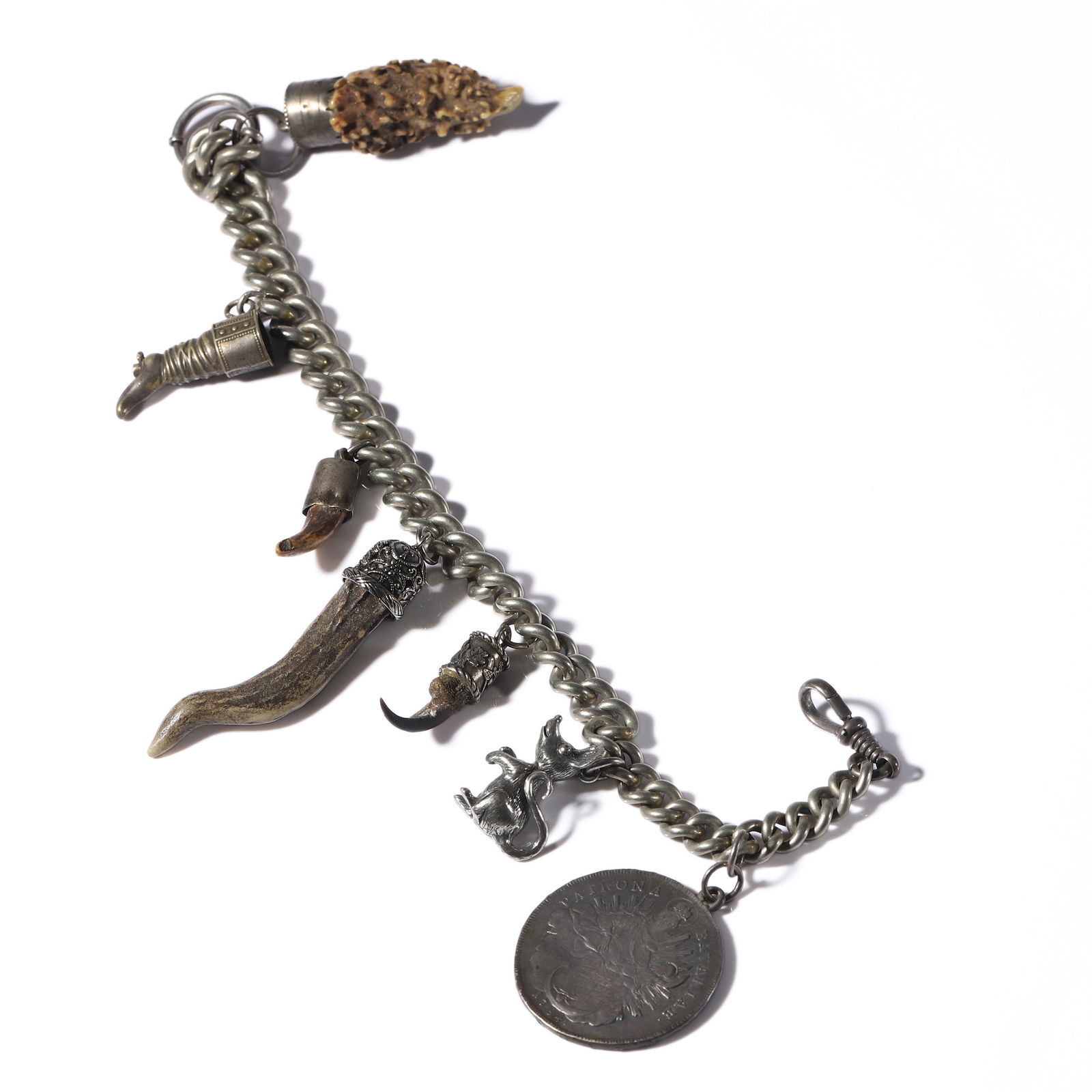 GERMAN, BAVARIA, 20TH CENTURY — TRADITIONAL LADIES’ CHARIVARI JEWELRY.: GERMAN, BAVARIA, 20TH CENTURY — TRADITIONAL LADIES’ CHARIVARI JEWELRY. Medium: Silver with animal claws, antler fragments, coin, and hunting charms Dimensions: Length: 13 3/8 in. (34 cm); Weight: